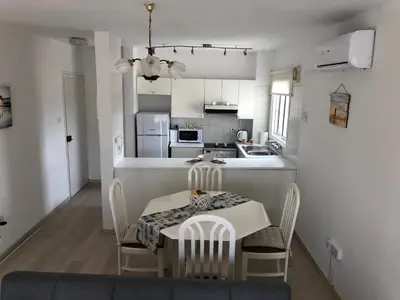 a kitchen and dining room with a table and chairs at Kypkeys Apartments in Voroklini