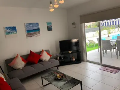 a living room with a couch and a television at Kypkeys Apartments in Voroklini