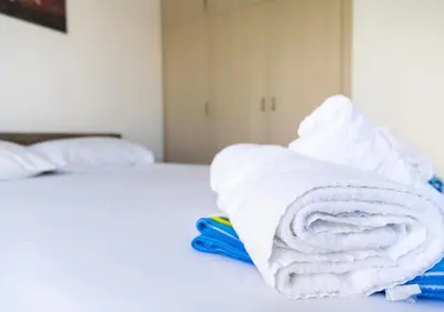 a pile of towels sitting on top of a bed at Kypkeys Apartments in Voroklini
