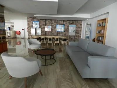 a living room with a couch and chairs and a table at Evabelle Napa Hotel Apartments in Ayia Napa
