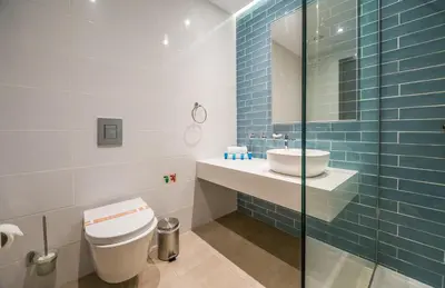 a bathroom with a toilet and a sink at Protaras Plaza Hotel in Protaras