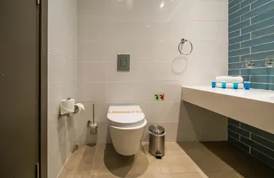 a bathroom with a toilet and a sink at Protaras Plaza Hotel in Protaras