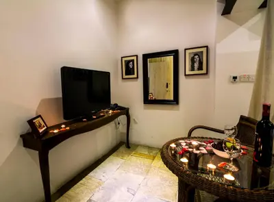 a living room with a tv and a table with candles at Anastou's Traditional House in Kalopanayiotis