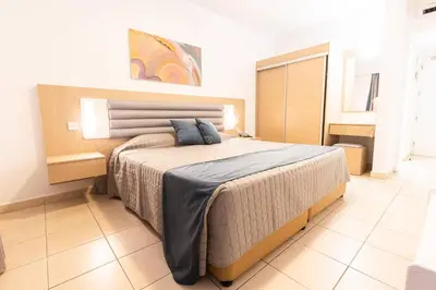 a bedroom with a large bed in a room at Vrissaki Hotel Apartments in Protaras