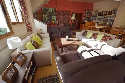 a living room with couches and a table at Christys Palace Hotel in Pedoulas