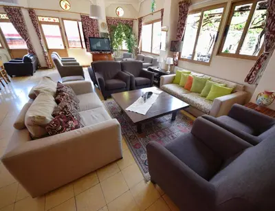 a large living room with couches and a table at Christys Palace Hotel in Pedoulas