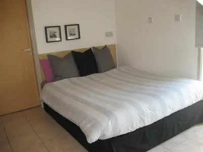 a bedroom with a large bed with white sheets and pillows at Lykavitos Apartments in Nicosia