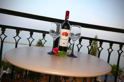 a bottle of wine and two glasses on a table at Pier Beach Hotel Apartments in Limassol