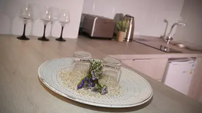 a plate with flowers on it on a kitchen counter at Pier Beach Hotel Apartments in Limassol