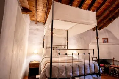 a bedroom with a bed with a canopy at Ambelikos Traditional Agrohotel in Potamitissa