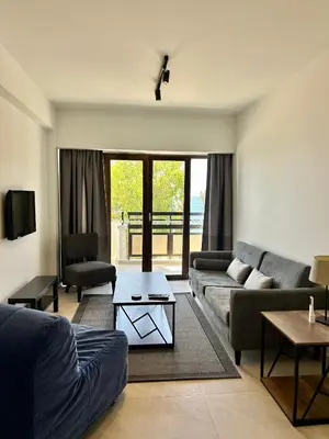 a living room with a couch and a table at Pigeon Beach Hotel Apartments in Limassol