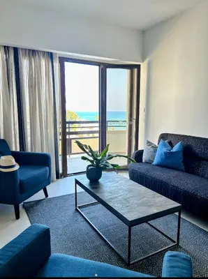 a living room with a couch and a coffee table at Pigeon Beach Hotel Apartments in Limassol