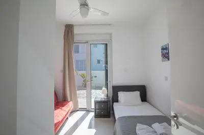 a bedroom with a bed and a sliding glass door at Villa Gardenia in Protaras