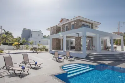 a villa with a swimming pool and a house at Villa Gardenia in Protaras