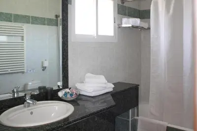 a bathroom with a sink and a mirror at Chrielka Hotel in Limassol