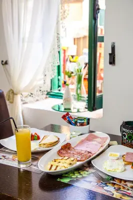 a table with plates of food and a glass of orange juice at Stou Kir Yianni in Omodos