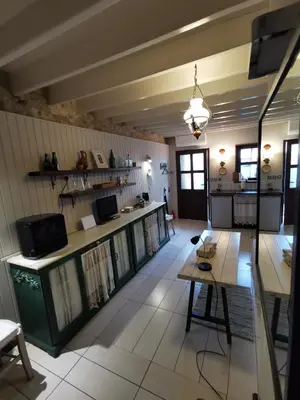 a living room with a table and a kitchen at Stou Kir Yianni in Omodos