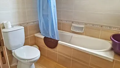 a bathroom with a toilet and a bath tub at Kapparis town house in Paralimni