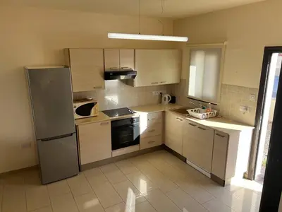 a kitchen with a stainless steel refrigerator and cabinets at Kapparis town house in Paralimni
