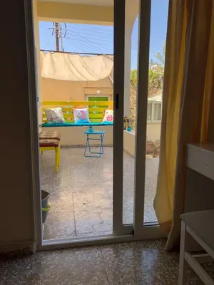 an open door to a patio with a couch outside at Lucky 4 in Paralimni