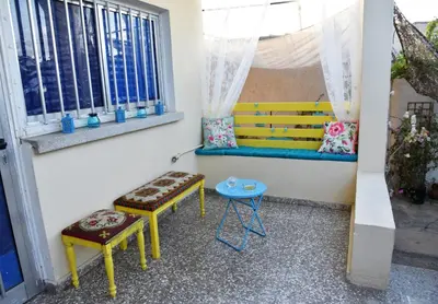 a room with a bench and two stools and a window at Lucky 4 in Paralimni