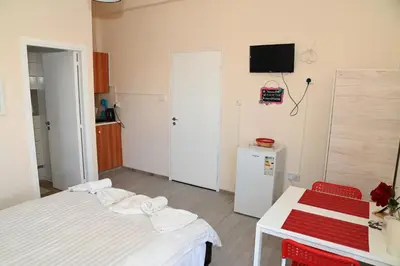 a room with two beds and a tv on the wall at Lucky 4 in Paralimni