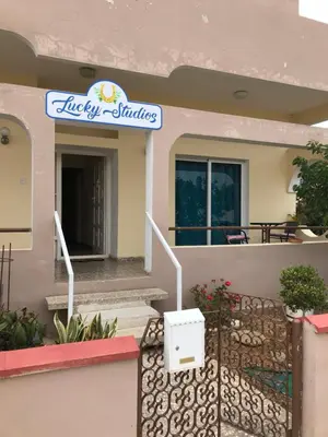 a house with a sign that reads happy studios at Lucky 5 in Paralimni