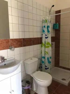 a bathroom with a toilet and a sink and a shower at Lucky 5 in Paralimni