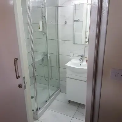 a bathroom with a shower and a sink at Olympia Traditional Houses in Lymbia