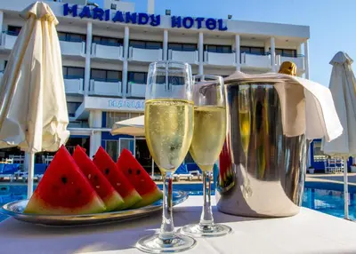 two glasses of wine and a plate of watermelon at Mariandy Hotel in Larnaka