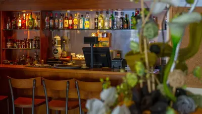 a bar with two chairs in front of a counter at Mariandy Hotel in Larnaka
