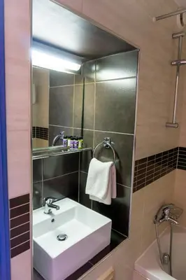 a bathroom with a sink and a mirror at Mariandy Hotel in Larnaka