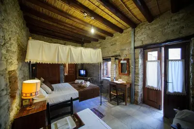a bedroom with a bed and a desk in a room at Teacher's House in Maroni