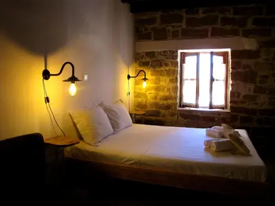 a bedroom with a bed in a room with a window at Teacher's House in Maroni