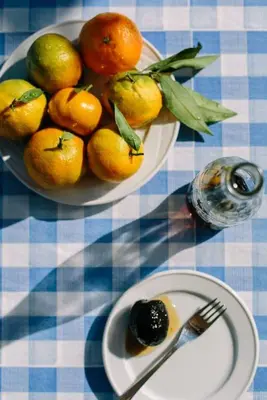 a table with two plates of oranges and a bowl of fruit at Teacher's House in Maroni