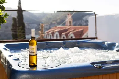 a bottle of wine and glasses in a hot tub at Kalavasos View Traditional Apartments in Kalavasos