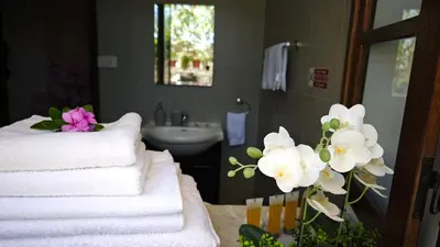 a bathroom with a stack of towels and flowers at Kozakos Luxury House in Pano Lefkara