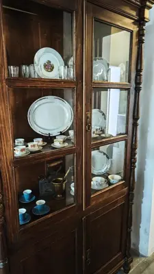 a wooden cabinet with plates and dishes in it at Kozakos Luxury House in Pano Lefkara