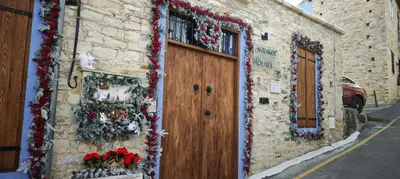 a building with christmas decorations on the side of it at Kozakos Luxury House in Pano Lefkara