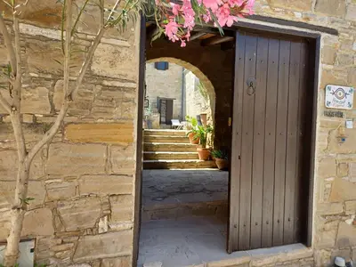 an entrance to a stone building with a wooden door at Vrakas House in Tochni