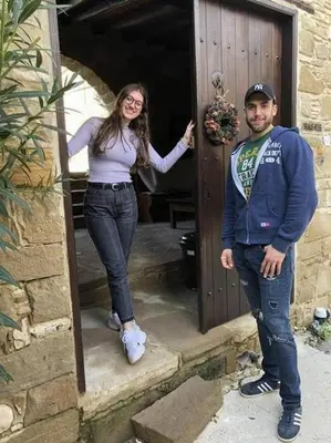 a man and a woman standing in front of a door at Vrakas House in Tochni