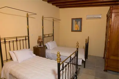 a bedroom with two beds in a room at Porfyrios Country House in Chirokitia