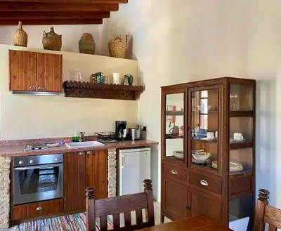 a kitchen with wooden cabinets and a counter top at Porfyrios Country House in Chirokitia