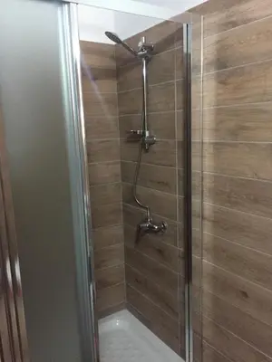 a shower with a glass door in a bathroom at Kasapis Apts in Larnaka