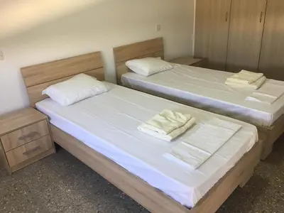 two beds sitting next to each other in a room at Kasapis Apts in Larnaka