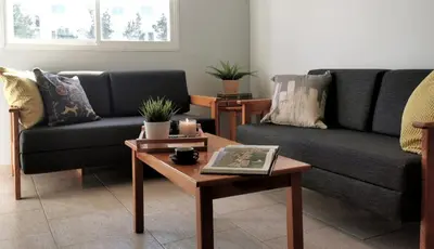 a living room with two couches and a coffee table at Anemomylos guesthouse in Paralimni