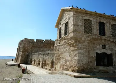 an old stone building on the side of the beach at Lazaros Centre Apartment in Larnaka