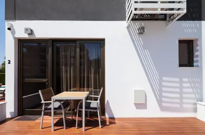 a table and chairs on the balcony of a building at The Jolo in Limassol