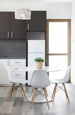 a kitchen with a white table and two white chairs at The Jolo in Limassol