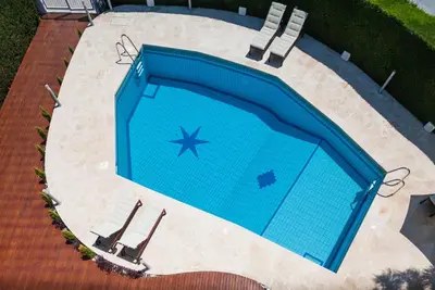an overhead view of a swimming pool with two chairs at The Jolo in Limassol